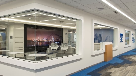 Water treatment facility with a large presentation room showing video of a boardwalk at night.