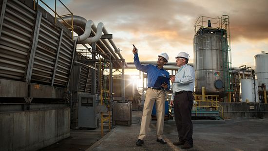 engineers pointing at cooling tower